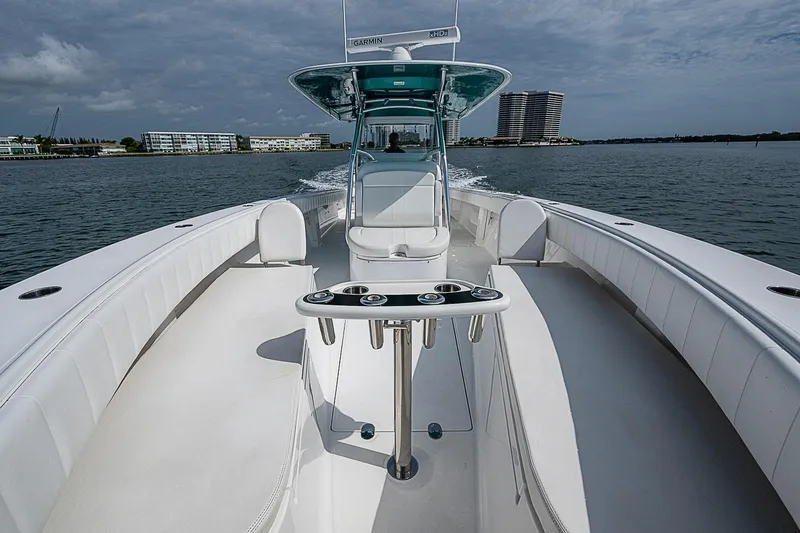 Slide: The Image of 2020 Bahama 41 boat cruising on water, featuring sleek white deck and modern design. - 7