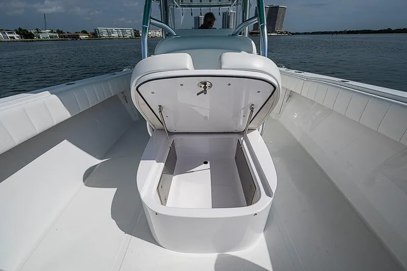 Slide: The Image of 2020 Bahama 41 boat with open storage compartment on deck, docked by waterfront buildings. - 9