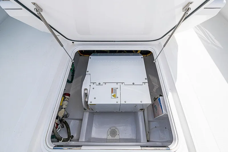Slide: The Image of Engine compartment of a 2020 Bahama 41 boat, showcasing mechanical components. - 24