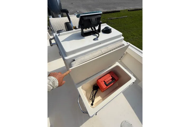 Slide: The Image of 2007 Parker 1801 Center Console boat with open storage compartment and red toolbox. - 10