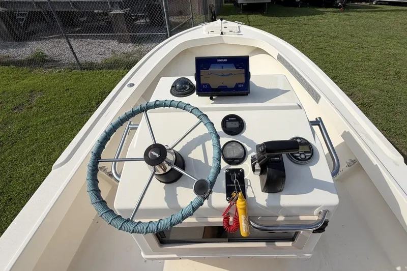 Slide: The Image of 2007 Parker 1801 Center Console boat dashboard with steering wheel and navigation equipment. - 13