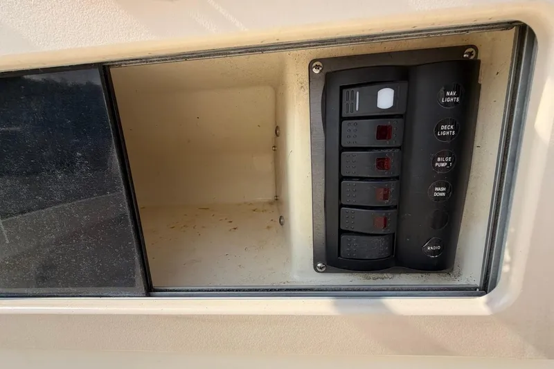 Slide: The Image of Control panel of a 2007 Parker 1801 Center Console boat with labeled switches. - 16
