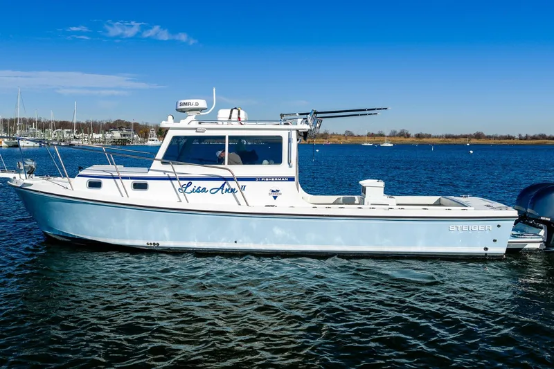 The Image of 2024 Steiger Craft 31 Fisherman boat on calm water under clear blue sky. - 1