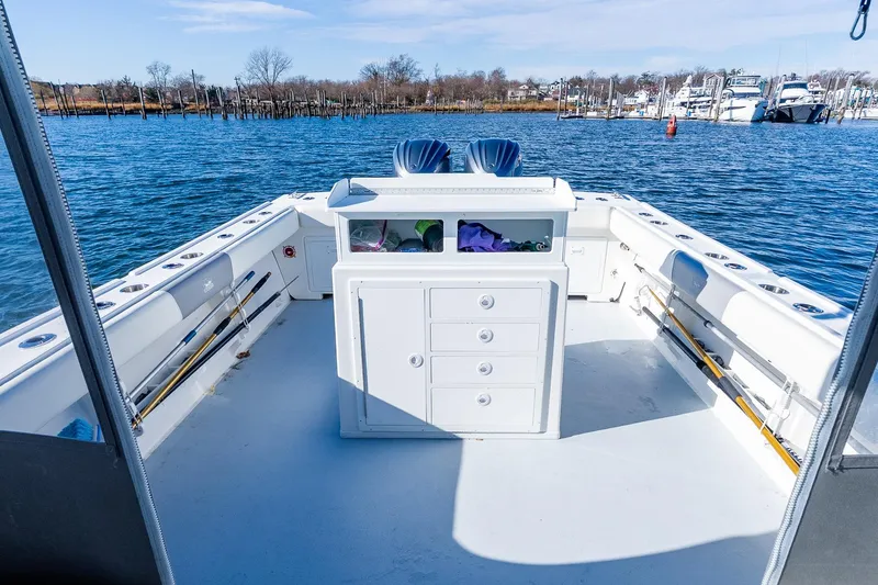 Slide: The Image of 2024 Steiger Craft 31 Fisherman boat deck with storage and fishing rods. - 12