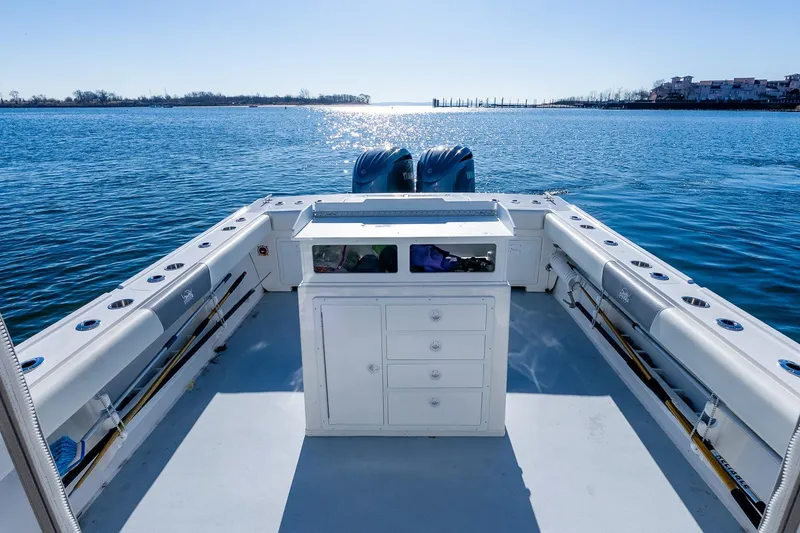 Slide: The Image of 2024 Steiger Craft 31 Fisherman boat on calm water, featuring spacious deck and dual engines. - 13