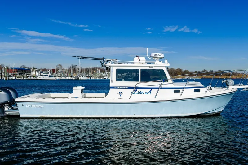 Slide: The Image of 2024 Steiger Craft 31 Fisherman boat on calm water under clear blue sky. - 3