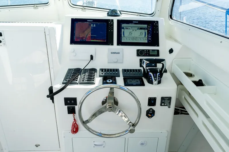 Slide: The Image of 2024 Steiger Craft 31 Fisherman helm with modern navigation and control systems. - 32