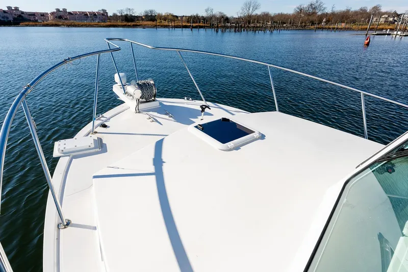 Slide: The Image of 2024 Steiger Craft 31 Fisherman boat on calm water, showcasing bow and railing. - 37