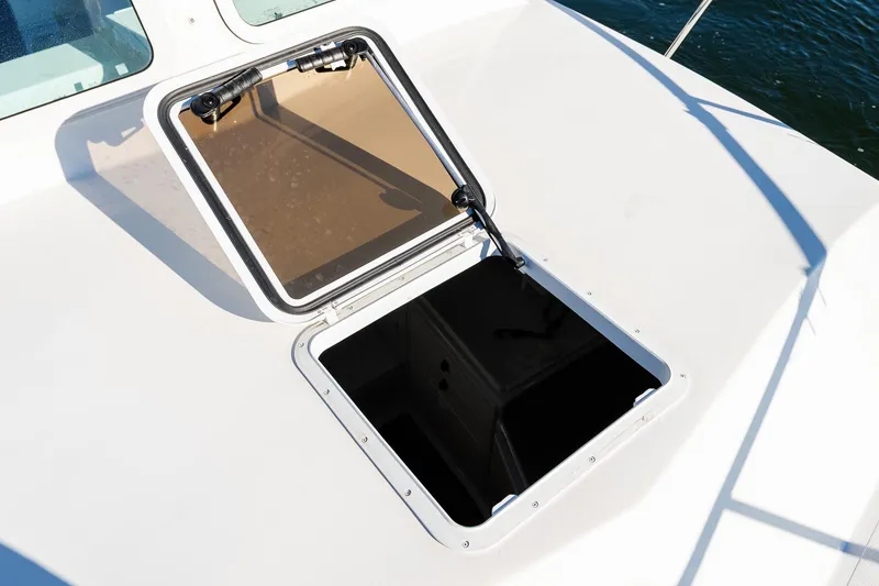 Slide: The Image of Open hatch on 2024 Steiger Craft 31 Fisherman boat deck, overlooking water. - 40