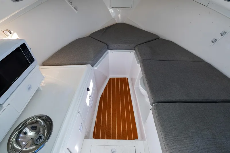 Slide: The Image of 2024 Steiger Craft 31 Fisherman cabin interior with seating, microwave, and sink. - 43