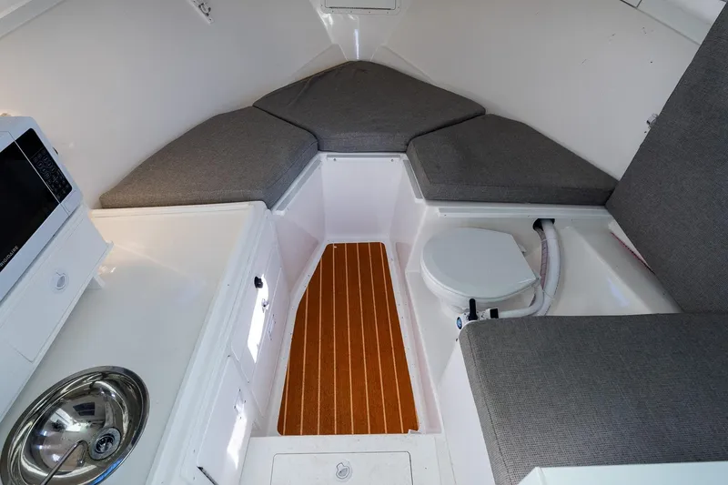 Slide: The Image of 2024 Steiger Craft 31 Fisherman cabin interior with seating, sink, and microwave. - 44