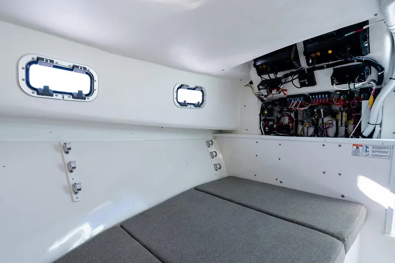 Slide: The Image of 2024 Steiger Craft 31 Fisherman cabin interior with wiring and cushioned seating. - 45