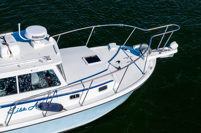 Slide: The Image of 2024 Steiger Craft 31 Fisherman boat on water, featuring Simrad equipment. - 7