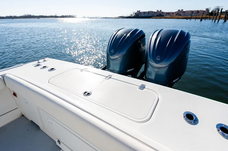 Slide: The Image of 2024 Steiger Craft 31 Fisherman boat with dual outboard motors on a sunny day. - 8