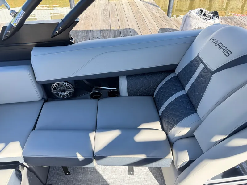Slide: The Image of The Harris Grand Mariner 230 features luxurious seating with elegant design on a wooden dock. - 14
