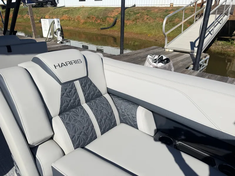 Slide: The Image of Luxurious seating area on a Harris Grand Mariner 230 pontoon boat, featuring gray and white upholstery. - 9