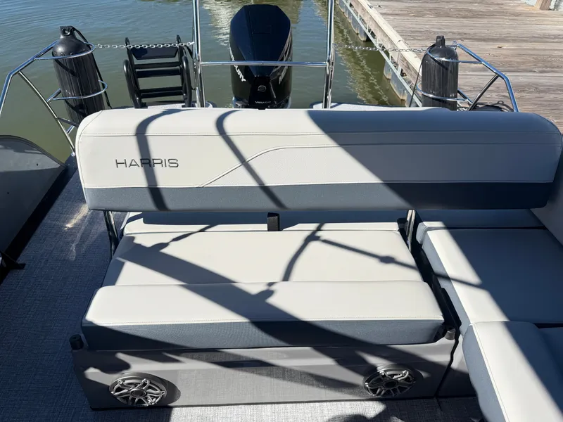 Slide: The Image of The 2027 Harris Grand Mariner 230 features a sleek bench seat with speakers at the stern. - 13