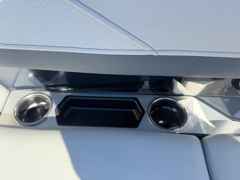 Slide: The Image of Close-up of cup holders and a storage compartment on a boat. - 10
