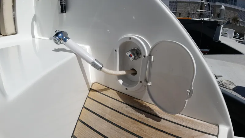 Slide: The Image of 2016 Beneteau GT35 boat deck with open hatch and hose connection. - 40