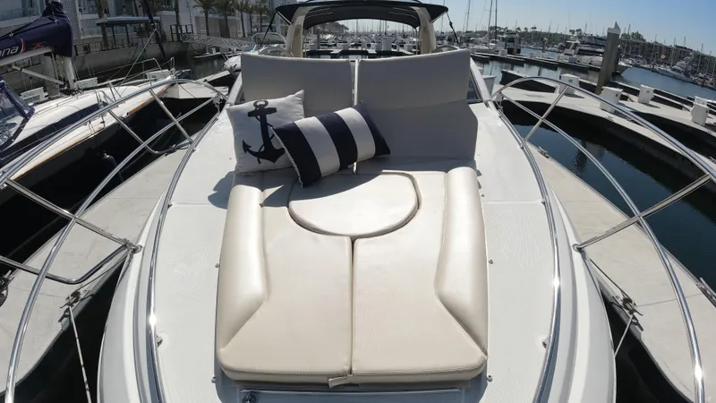 Slide: The Image of 2016 Beneteau GT35 yacht with sunbathing deck and nautical-themed cushions in a marina. - 5