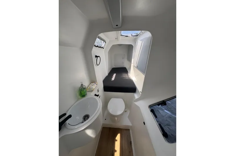 Slide: The Image of 2023 Schionning Arrow 1280S interior with compact bathroom and bed. - 22