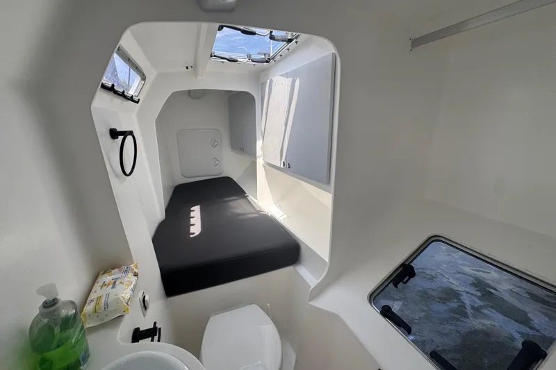 Slide: The Image of Interior cabin of 2023 Schionning Arrow 1280S catamaran with bed and porthole. - 23