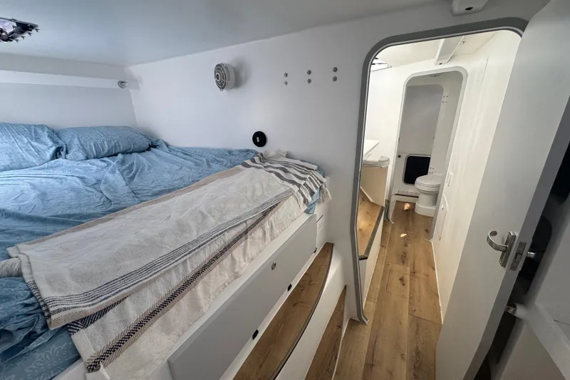 Slide: The Image of Interior of 2023 Schionning Arrow 1280S yacht, featuring cozy bedroom and modern bathroom. - 24