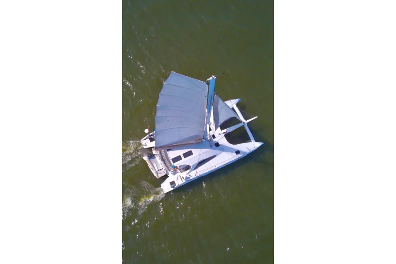 Slide: The Image of Aerial view of 2023 Schionning Arrow 1280S catamaran sailing on open water. - 3