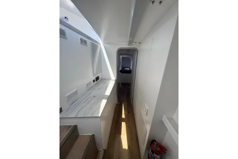Slide: The Image of Interior of 2023 Schionning Arrow 1280S yacht, featuring sleek white design and wooden flooring. - 30