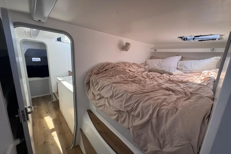 Slide: The Image of Cozy cabin interior of 2023 Schionning Arrow 1280S with bed and natural light. - 33