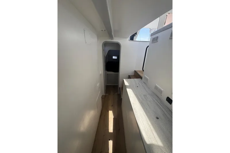 Slide: The Image of Interior view of 2023 Schionning Arrow 1280S catamaran, featuring sleek design and modern finishes. - 34
