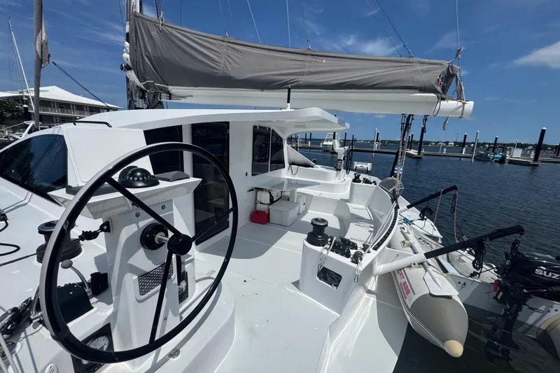 Slide: The Image of 2023 Schionning Arrow 1280S catamaran docked, featuring sleek design and modern sailing equipment. - 8