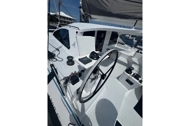 Slide: The Image of 2023 Schionning Arrow 1280S catamaran cockpit with steering wheel and winches. - 9