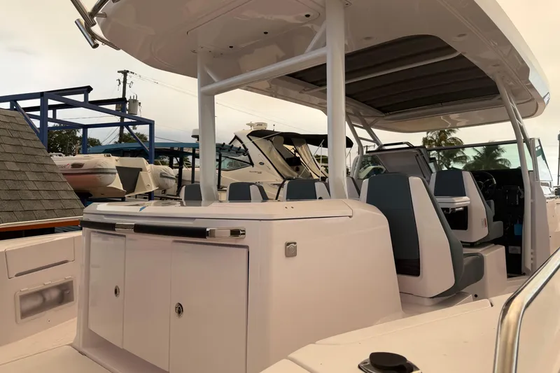 Slide: The Image of 2024 Axopar 37 Sun-Top boat interior with seating and helm, showcasing modern design. - 12