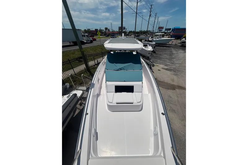 Slide: The Image of 2024 Axopar 37 Sun-Top boat with sleek design, docked outdoors. - 3