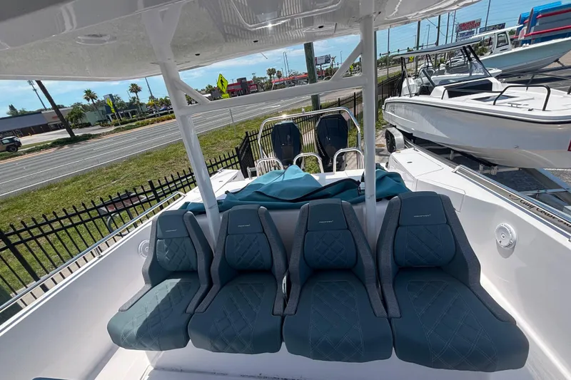 Slide: The Image of 2024 Axopar 37 Sun-Top boat with luxurious seating and sleek design. - 6