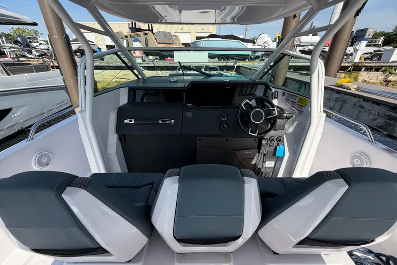 Slide: The Image of 2024 Axopar 37 Sun-Top boat interior with modern helm and seating. - 8