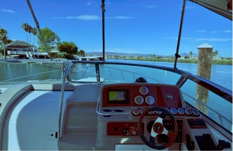 Slide: The Image of 2003 Formula 37 PC boat cockpit with scenic waterfront view. - 13