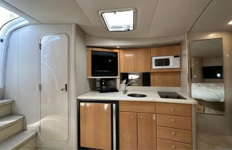Slide: The Image of Interior of 2003 Formula 37 PC yacht with kitchenette, microwave, and compact fridge. - 16