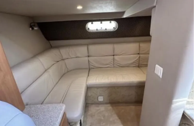 Slide: The Image of 2003 Formula 37 PC yacht interior with beige leather seating and porthole window. - 21