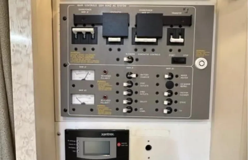 Slide: The Image of Electrical control panel of a 2003 Formula 37 PC boat, featuring switches and gauges. - 24