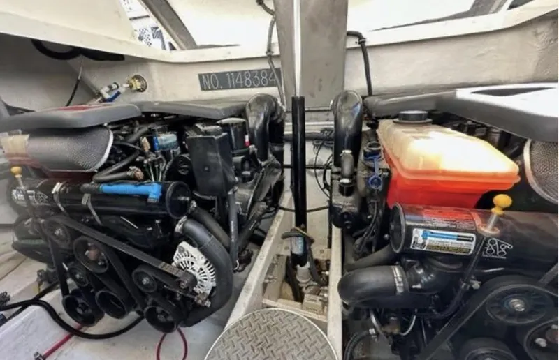 Slide: The Image of Engine compartment of a 2003 Formula 37 PC boat, showcasing dual engines and mechanical components. - 30
