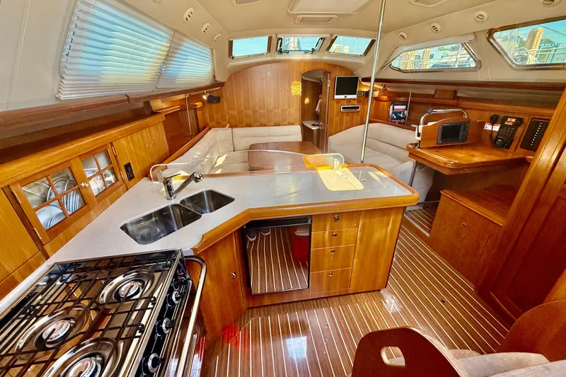 Slide: The Image of Luxurious 2007 Hunter 41 Deck Salon interior with modern kitchen and cozy seating area. - 11