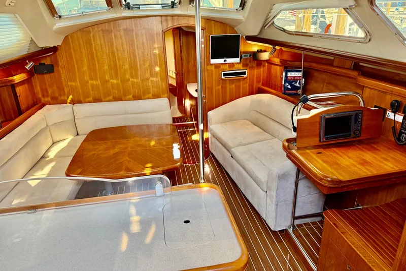 Slide: The Image of Luxurious interior of 2007 Hunter 41 Deck Salon with wood finish and plush seating. - 12
