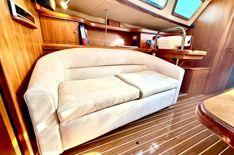 Slide: The Image of Luxurious interior of 2007 Hunter 41 Deck Salon with plush sofa and wooden accents. - 14