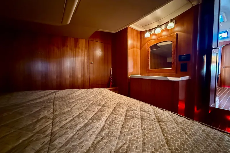 Slide: The Image of Luxurious interior of 2007 Hunter 41 Deck Salon yacht with wood paneling and cozy bedding. - 19