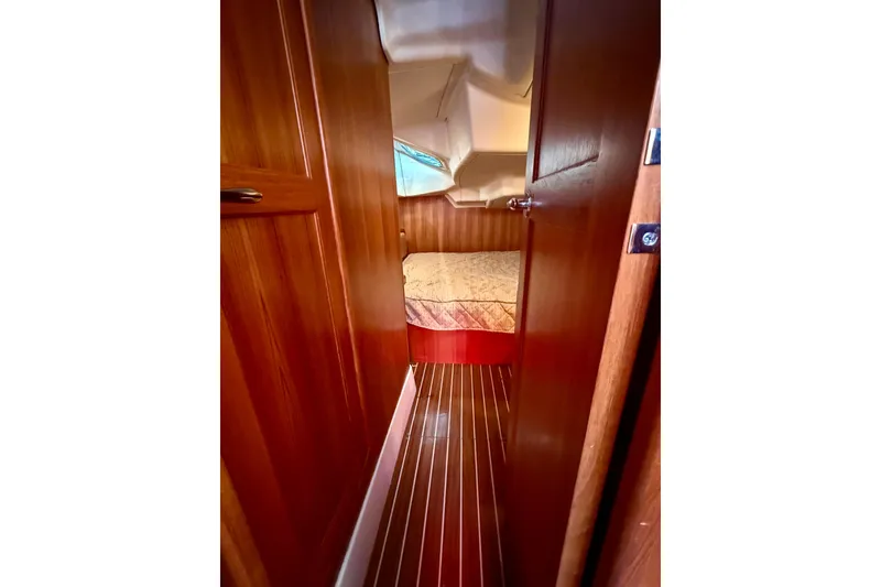 Slide: The Image of Interior view of 2007 Hunter 41 Deck Salon, featuring wooden cabin and cozy bed. - 20