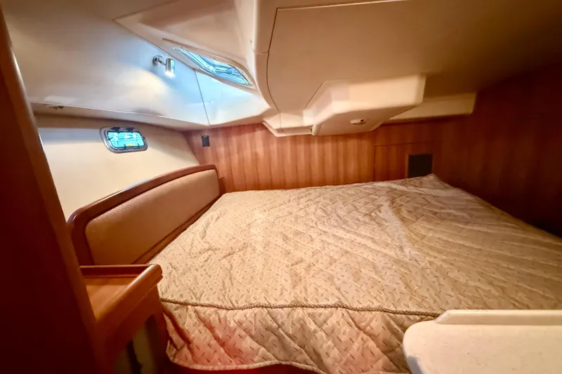 Slide: The Image of Cozy cabin interior of 2007 Hunter 41 Deck Salon yacht with wood paneling and bedding. - 27
