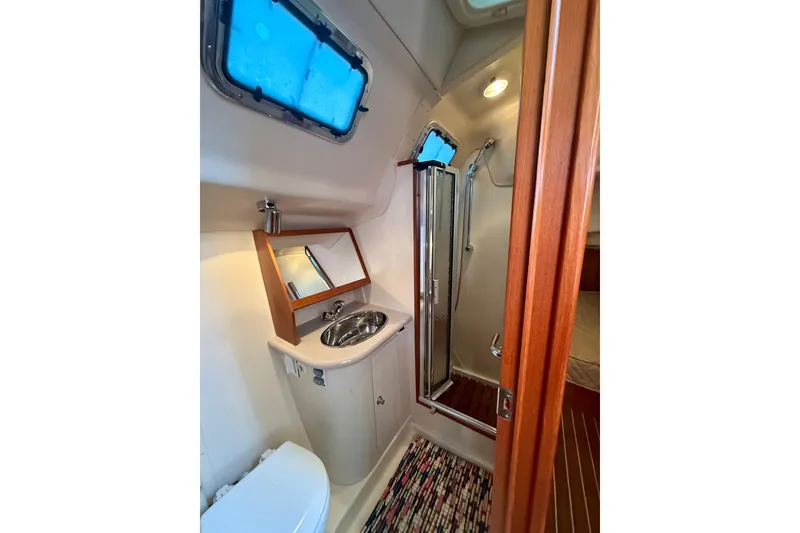 Slide: The Image of Bathroom interior of 2007 Hunter 41 Deck Salon yacht with sink, mirror, and shower. - 28