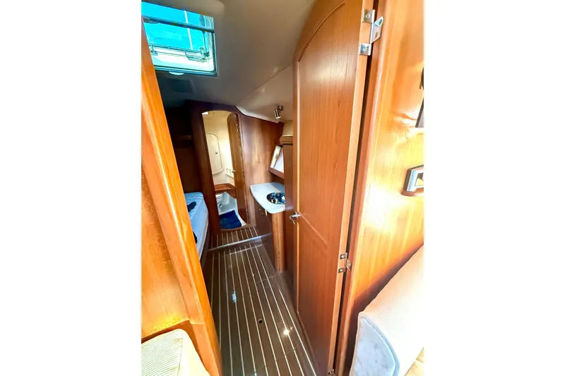 Slide: The Image of Interior view of 2007 Hunter 41 Deck Salon yacht, featuring wood paneling and modern amenities. - 30